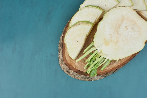 Sliced celery corn on a wooden board.