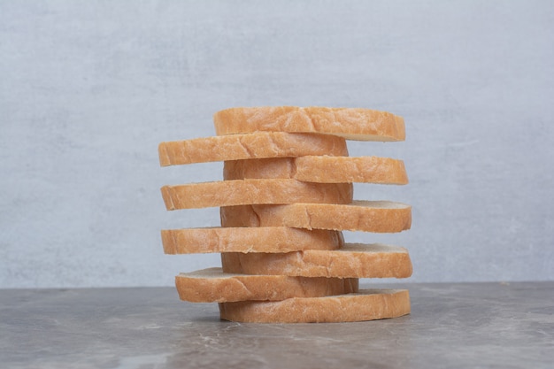 Free photo sliced of fresh bread on marble surface