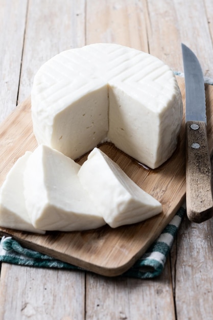 Free Photo sliced fresh white cheese from cow's milk on wooden table