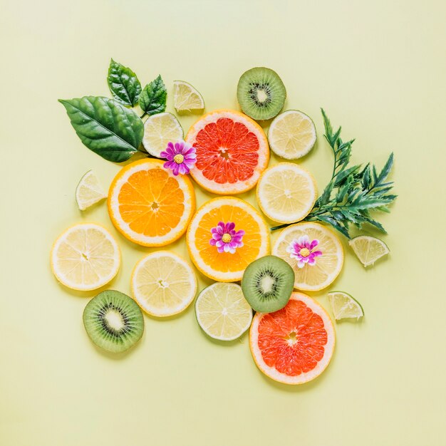 Sliced fruits decorated with leaves and flowers