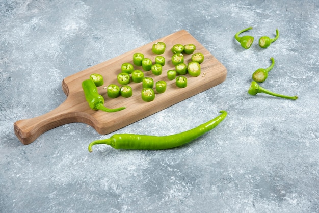 Free Photo sliced jalapeno peppers on wooden board.