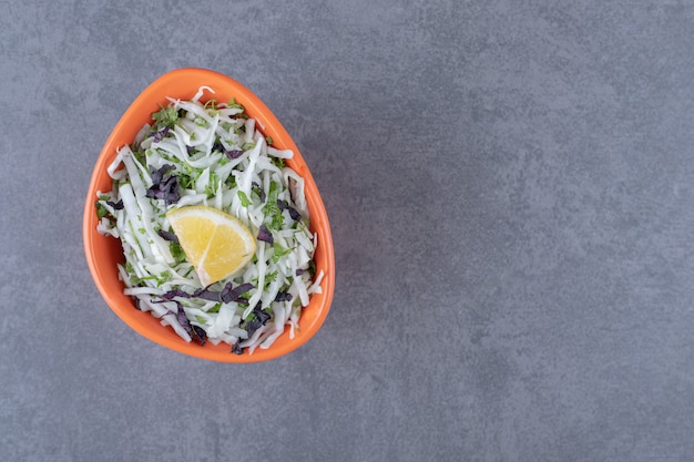 Free Photo sliced lemon with grated vegetables, on the marble surface.