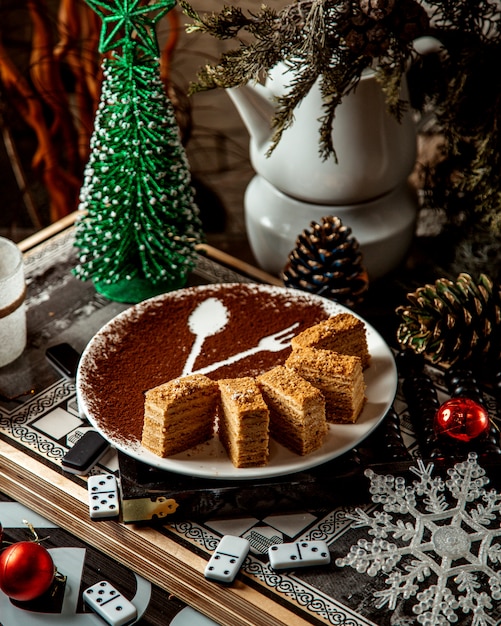 Free Photo sliced mead dessert on plate with cacao drawing