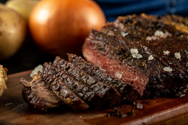 Sliced meat barbecue served with onion and sea salt