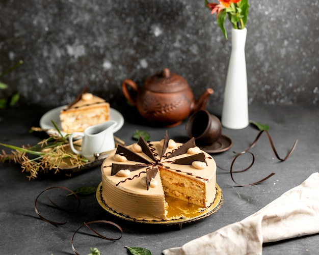 Sliced round cake with coffee cream and chocolate pieces