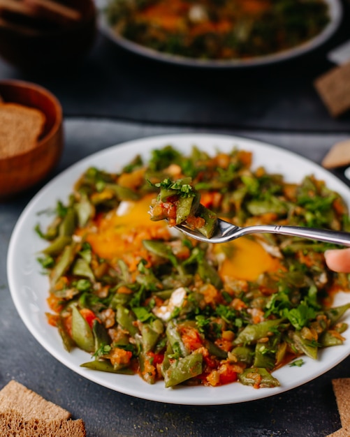 sliced vegetable meal fried colorful vegetables meal along wtih bread loafs eggs inside white plate on grey