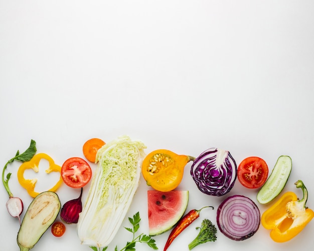 Sliced vegetables on white background with copy space