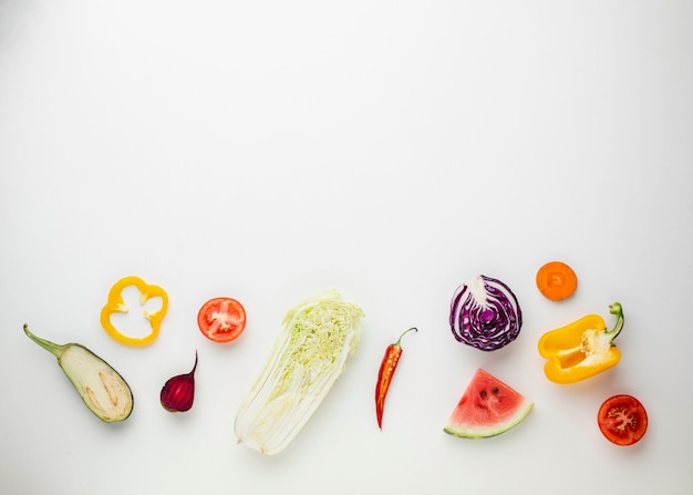 Free photo sliced veggies on white background