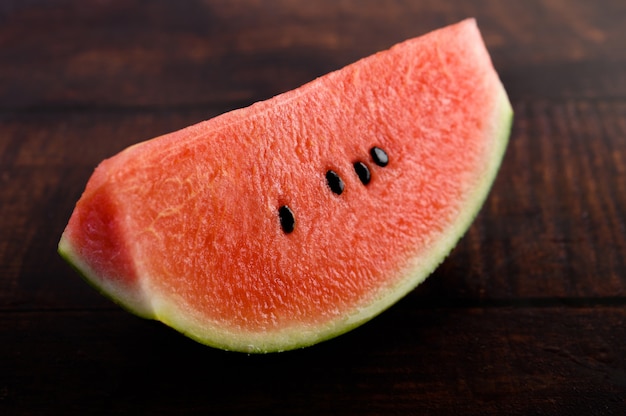 Sliced watermelon on a wooden table.