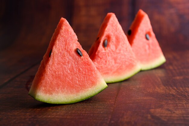 Sliced watermelon on a wooden table.