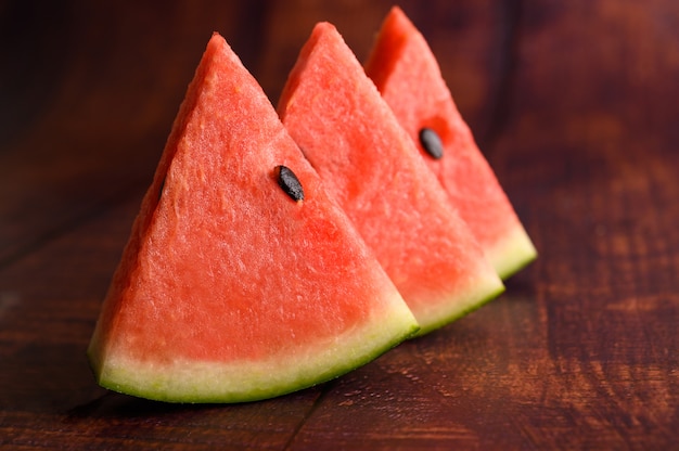 Sliced watermelon on a wooden table.