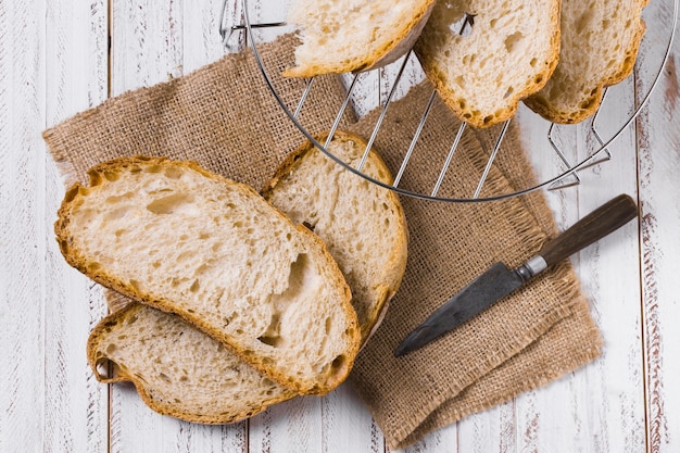 Slices of bread and iron basket top view