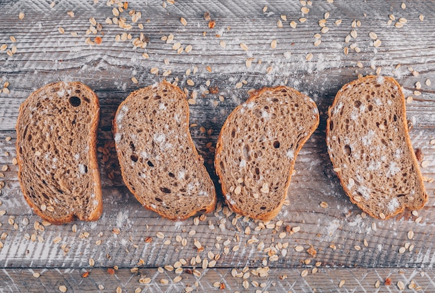 Free photo slices of bread top view on a wooden surface