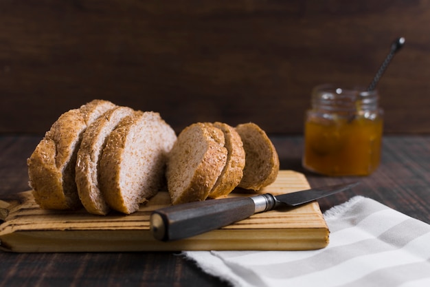 Slices of bread on wooden board with honey