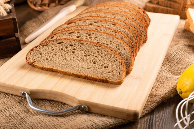 Slices of brown bread on kitchen board