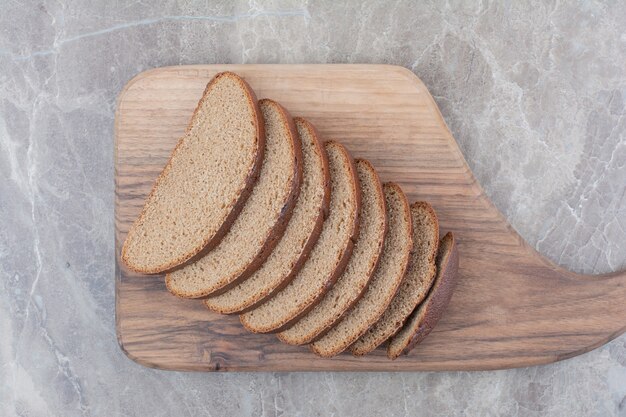 Slices of brown bread on marble surface