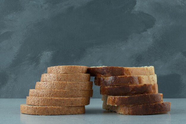 Slices of fresh bread on stone table