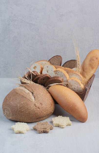 Slices of fresh breads on marble background.