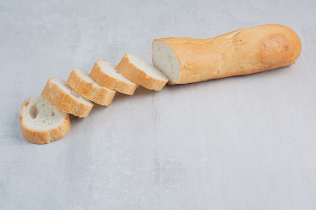 Slices of fresh white breads on marble background.