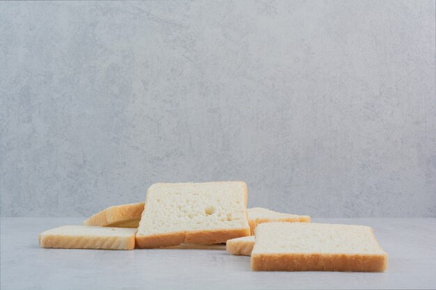 Slices of fresh white breads on marble background. 