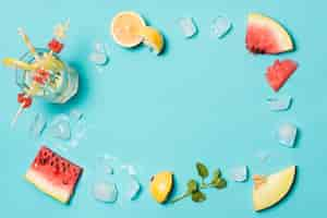 Free photo slices of fruits between ice and summer title on glass