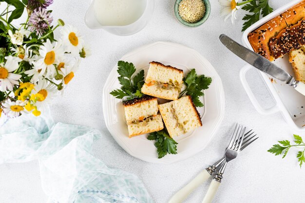 Free photo slices of homemade pie with vegetables on a white plate