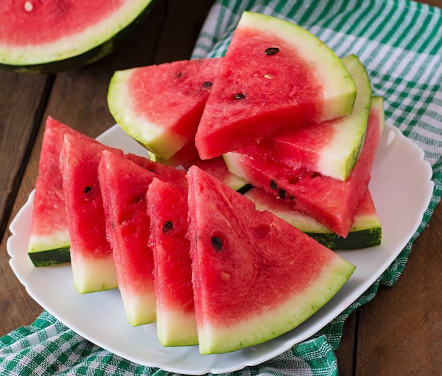 Slices of juicy and tasty watermelon on a white plate