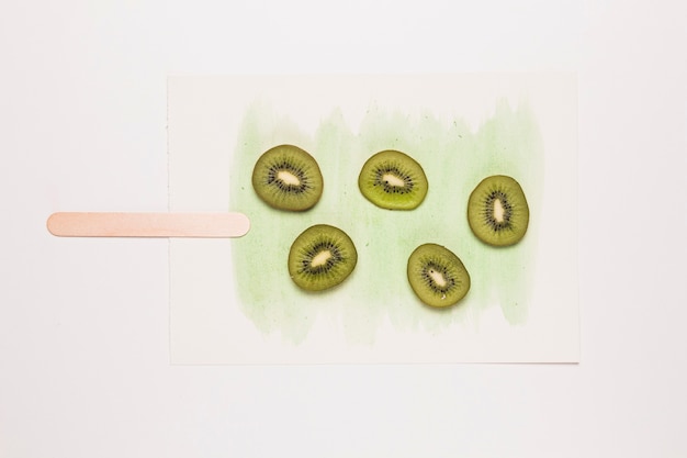 Free photo slices kiwi fruit on watercolor painted in shape of ice cream