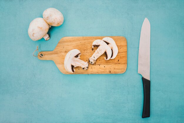 Slices of mushrooms on wooden board