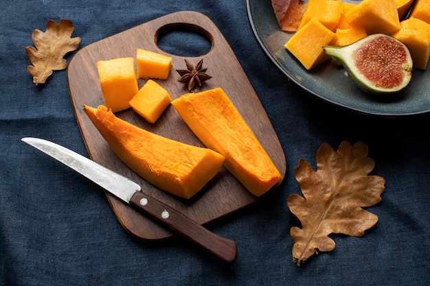 Slices of pumpkin on wooden board