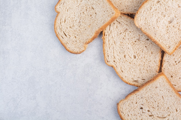 Slices of rye bread on stone background. High quality photo