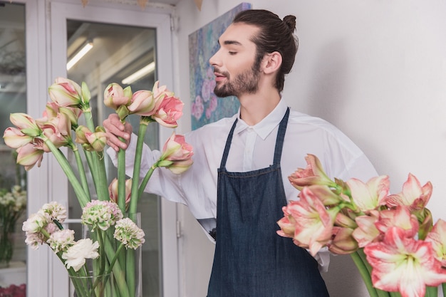 Small business. Male florist in flower shop.  making decorations and arrangements