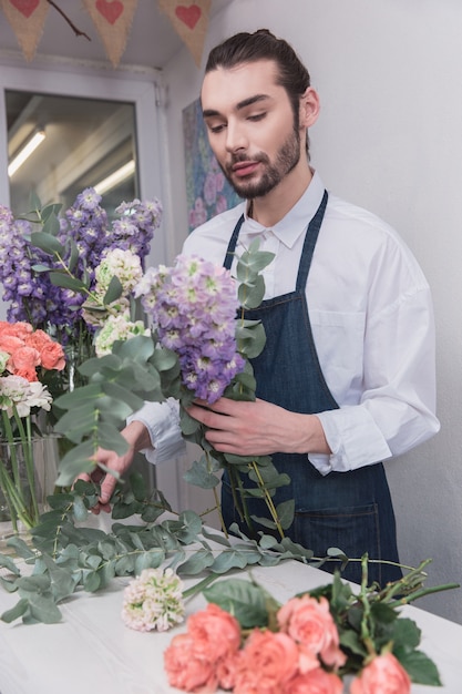 Free photo small business. male florist in flower shop.