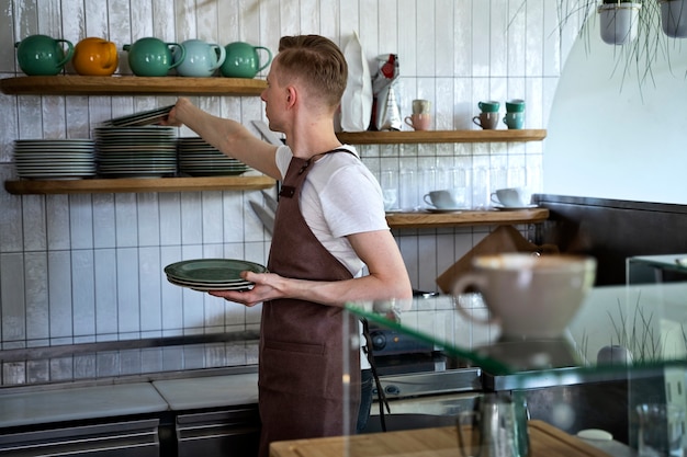 Small business owner cleaning up coffee shop