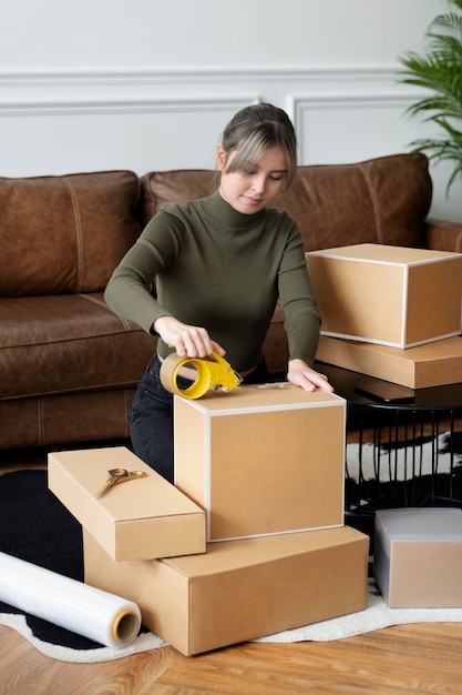 Free photo small business owner packing product parcel boxes for delivery