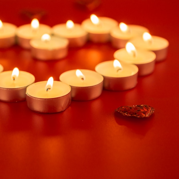 Free photo small candles with heart on table