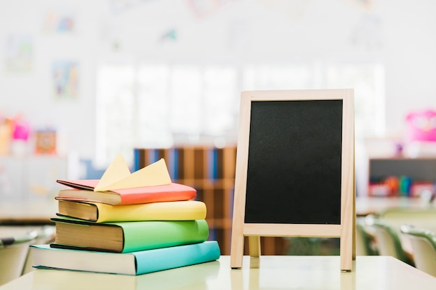 Small chalk board and books on desk