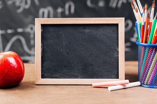 Small chalkboard near stationery on table