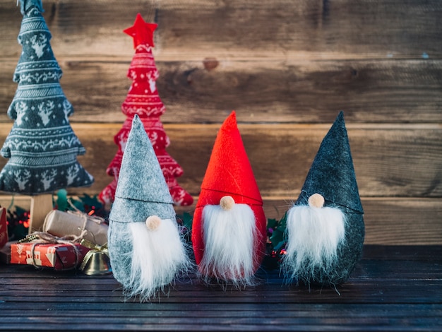 Free Photo small christmas elves on wooden table 