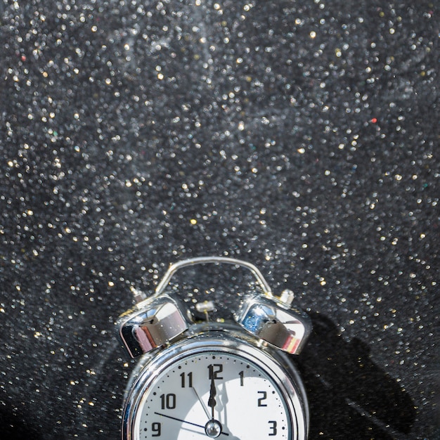 Free Photo small clock on shiny table