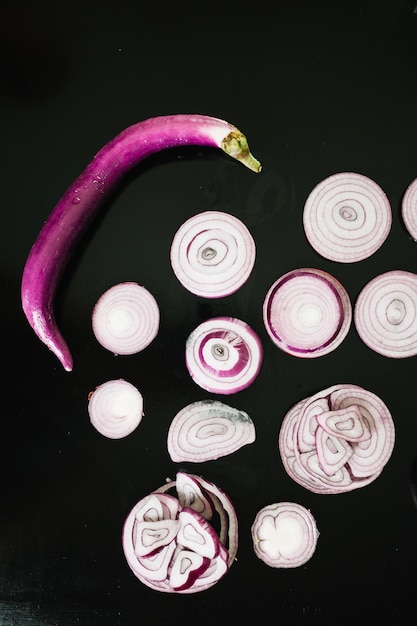 Small eggplant near sliced onions