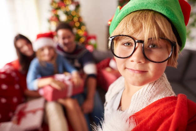 Small elf with sack of Christmas present for family