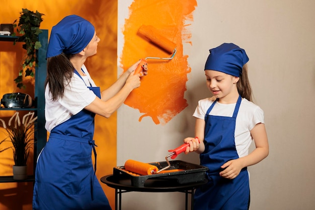 Free Photo small family painting orange walls