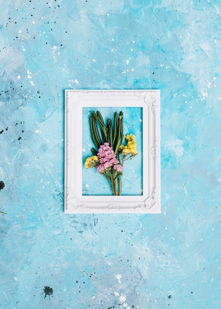 Small flowers branches in frame on table