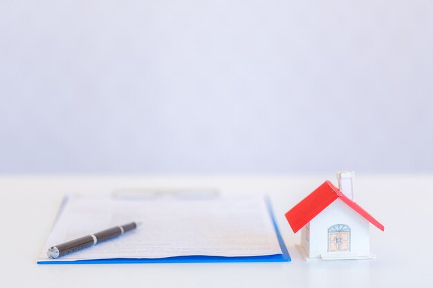 Small houses modern design and documents with pen on white 