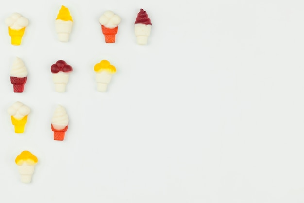 Small ice cream figures on light background