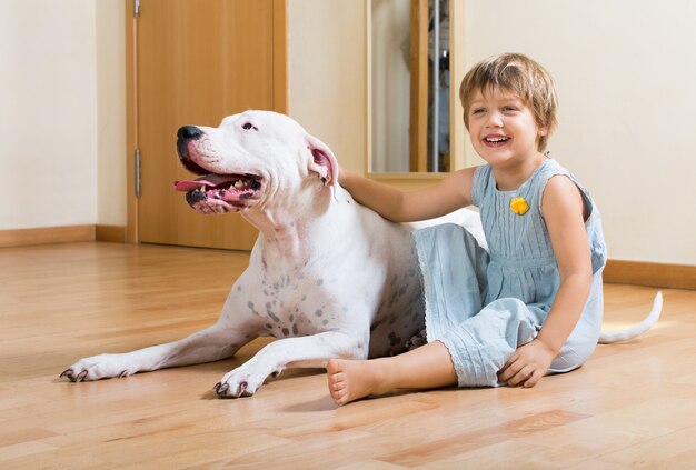 small nice girl on the floor with dog