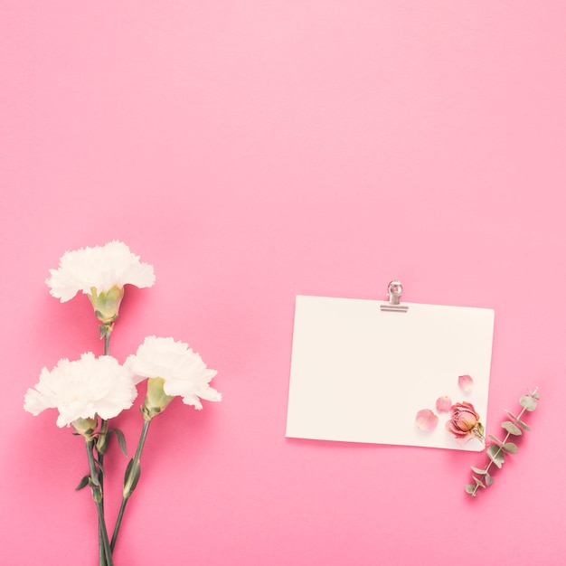 Small paper sheet with white flowers on table