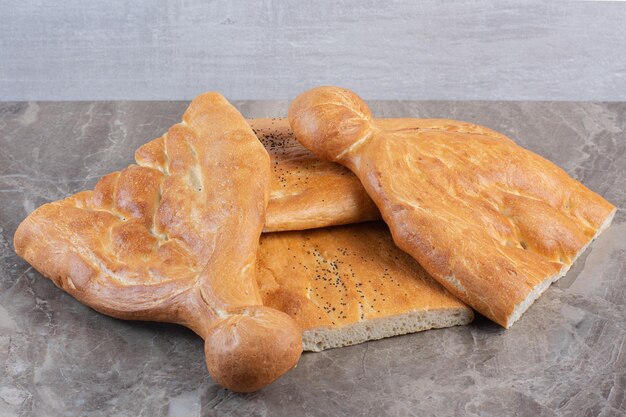 Small pile of half-sliced tandoori bread on marble background. High quality photo