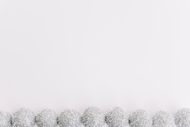 Free photo small silver baubles on white table